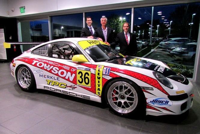 Mike Levitas of TPC Racing posing with his GT3 Cup Car at Porsche of Towson